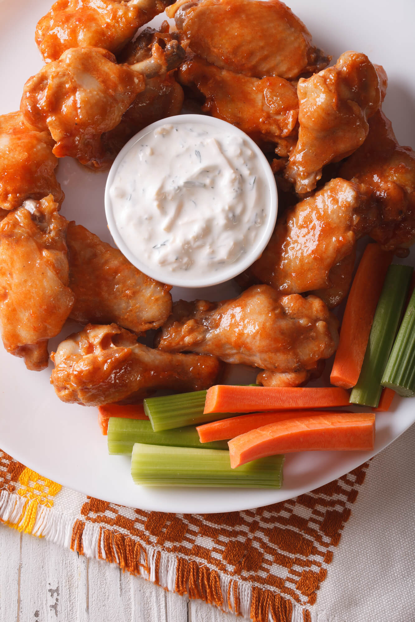 Crispy baked buffalo wings with ranch dressing, celery, and carrots.