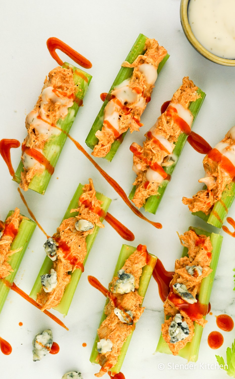 Low Carb Buffalo Chicken Celery Bites with celery and ranch dressing.