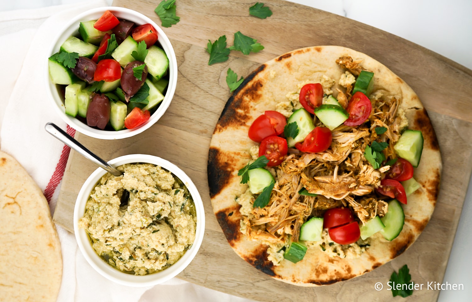 Weight Watchers Chicken Shawarma on a wooden cutting board with hummus.