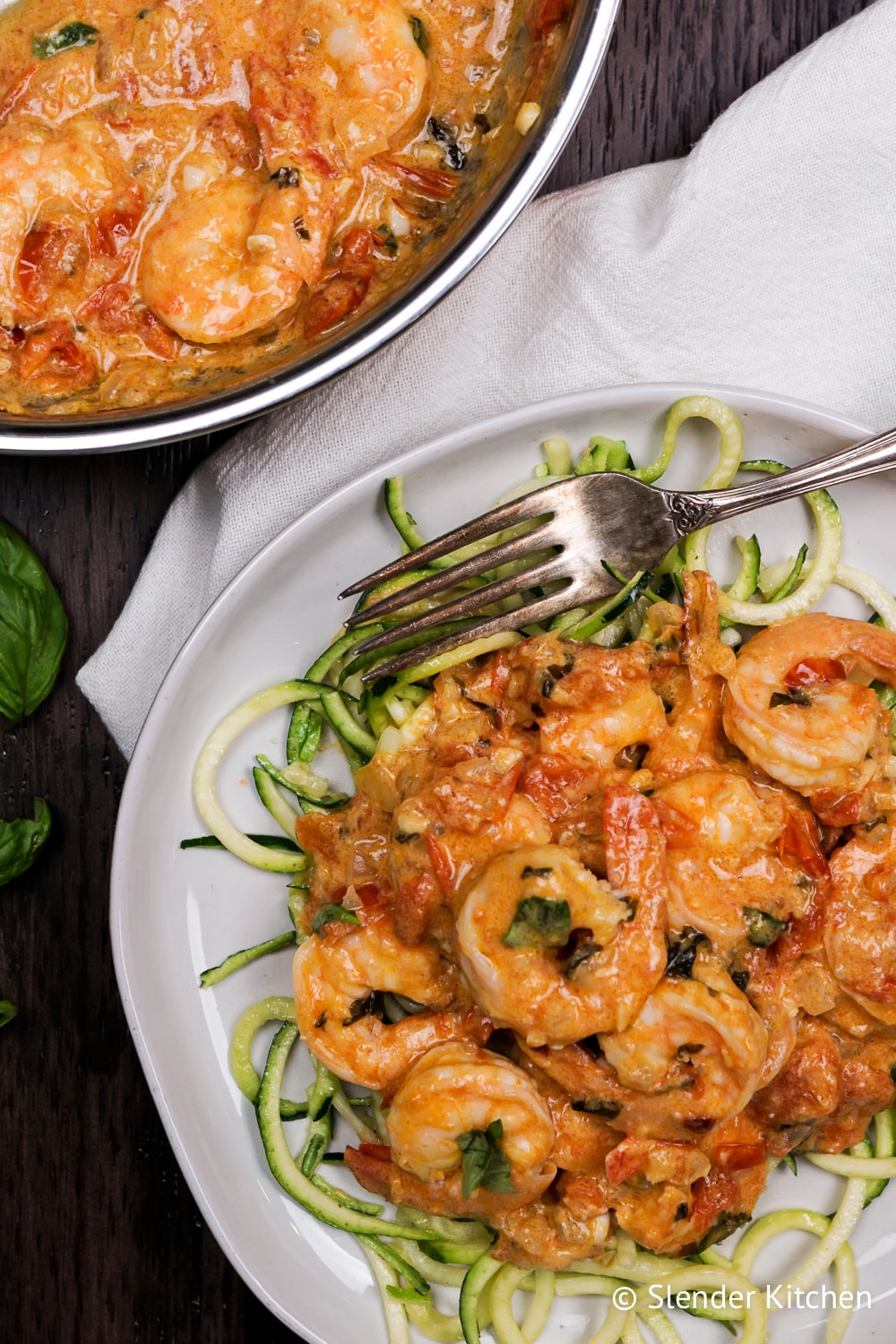 Paleo Creamy Coconut Shrimp and Tomato in a pan with zucchini noodles.