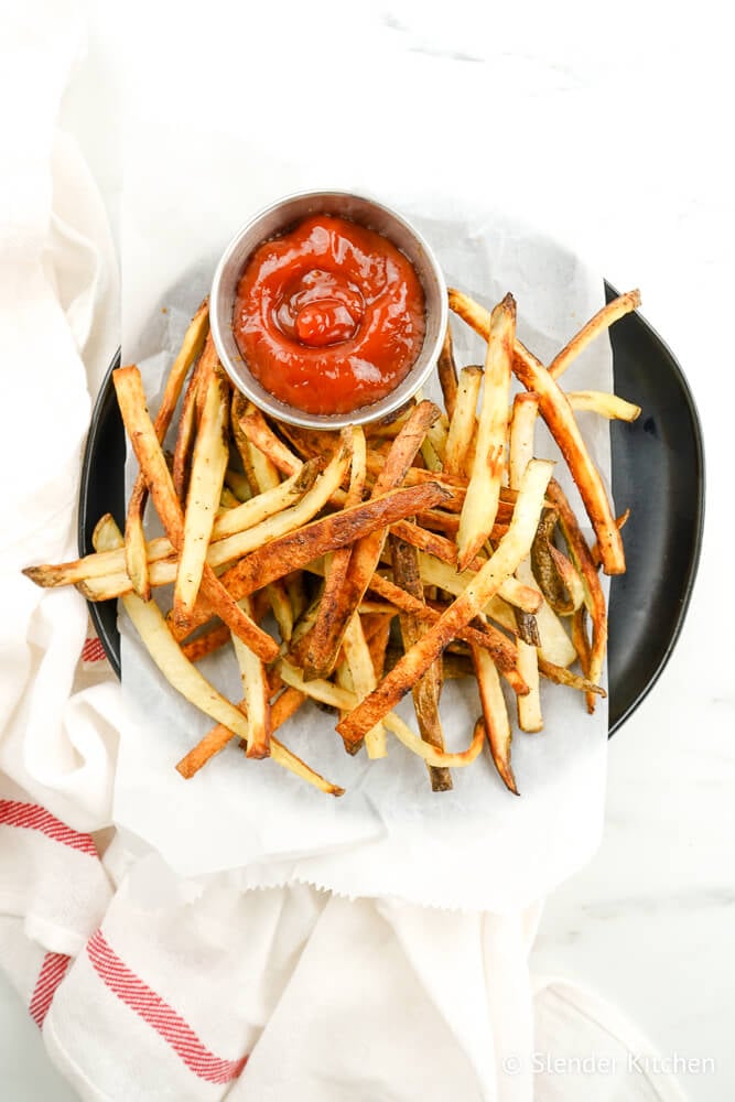 Turnip fries on a plate with ketchup.