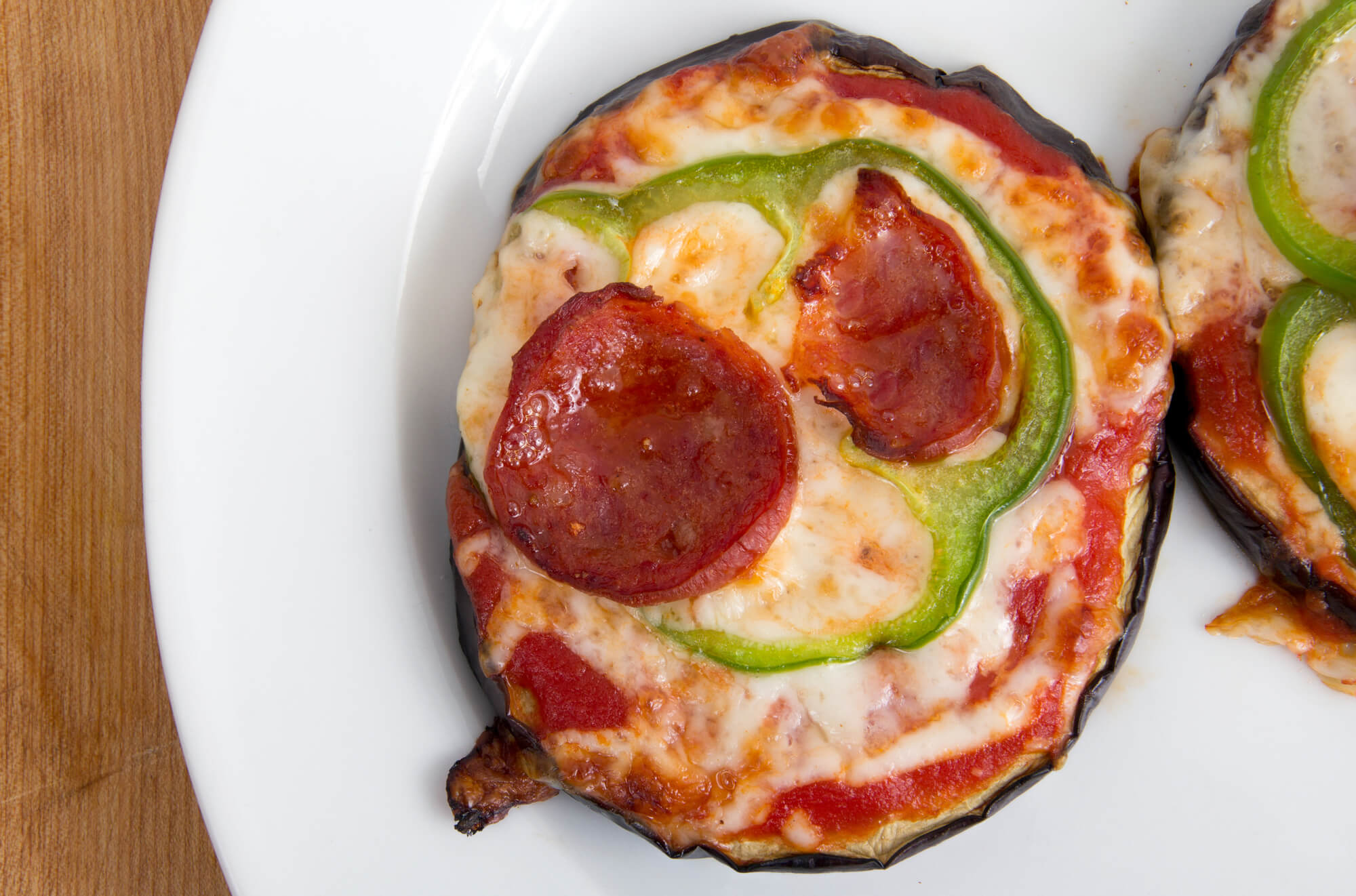 Low carb Eggplant pizza on a white plate.