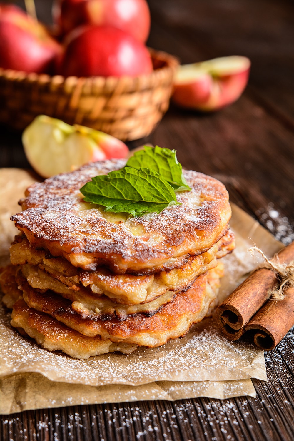 Low Carb Cinnamon Apple Pancakes on a plate with powdered sugar.