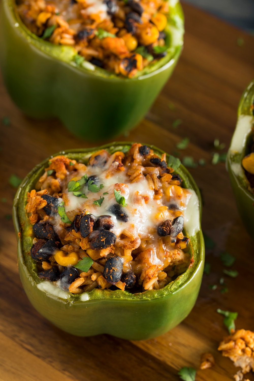 Vegetarian stuffed bell peppers filled with rice, beans, corn, and barbecue sauce.