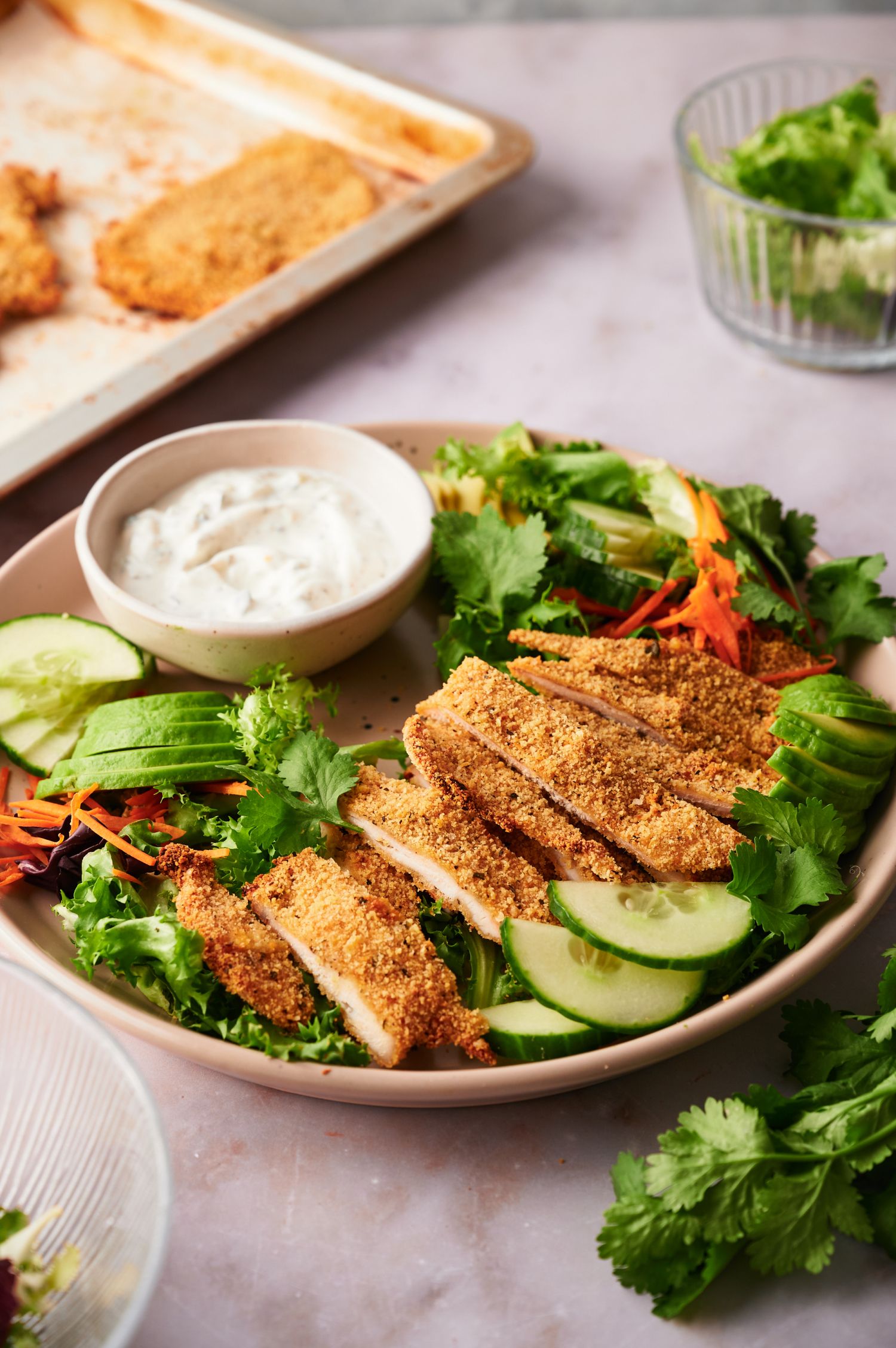 Crispy baked chicken cutlets served on a green salad with ranch dressing. 