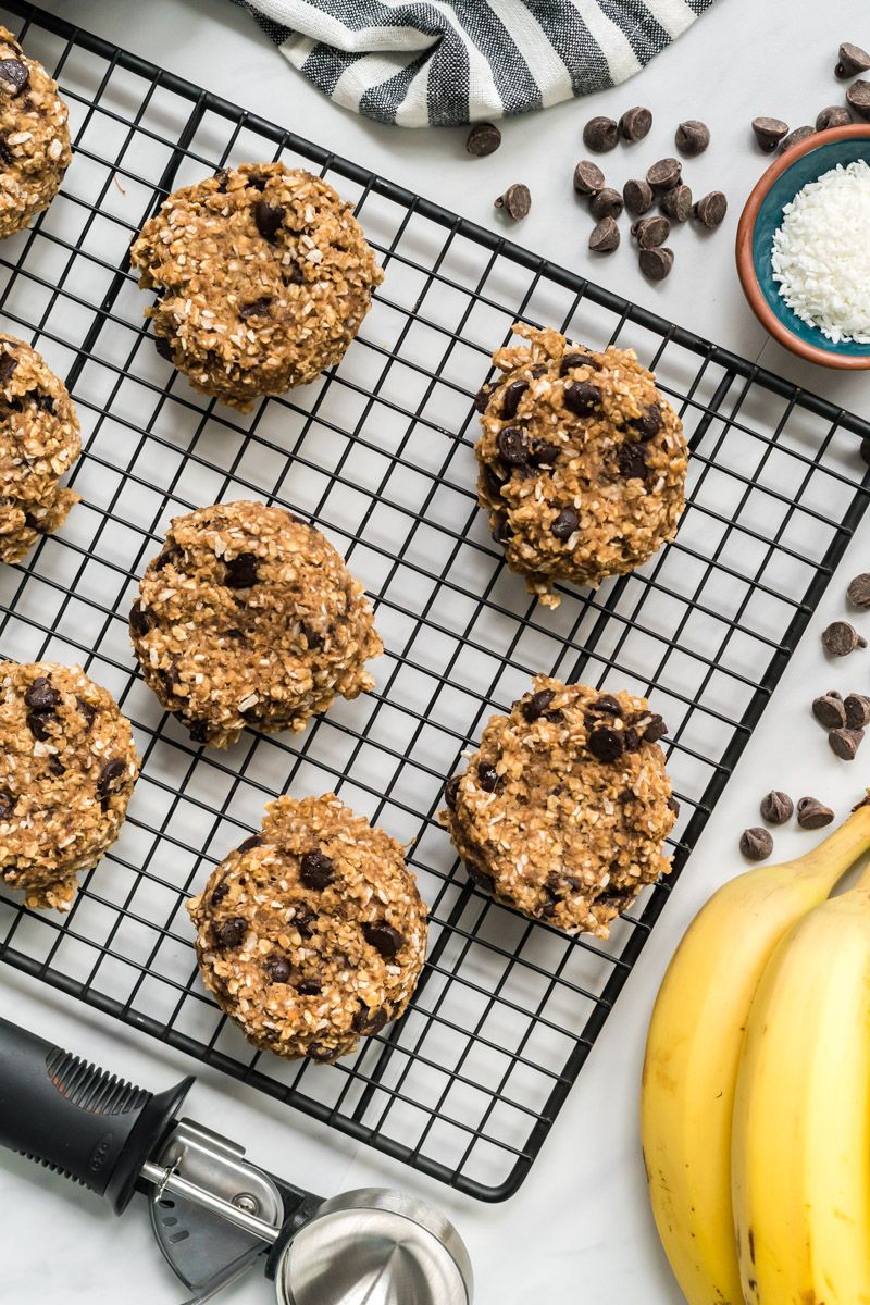 Banana Oatmeal cookies with chocolate chips and shredded coconut on a wire rack.