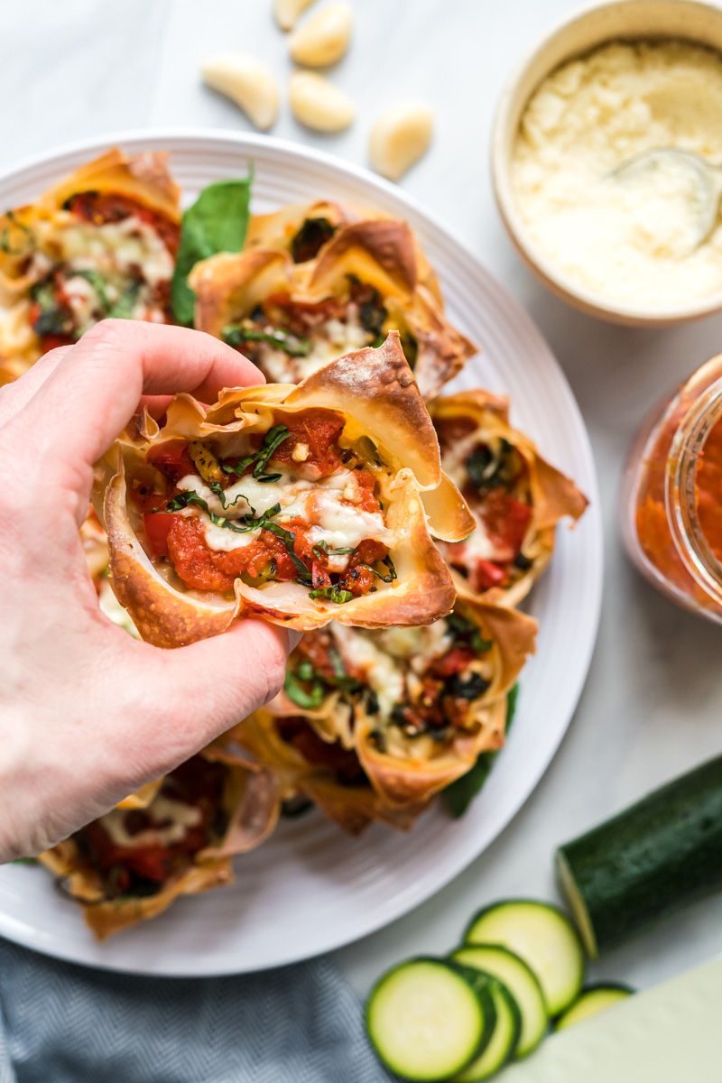 Lasagna muffins with sauteed vegetables, marinara sauce, and melted cheese cooked in a wonton wrapper.