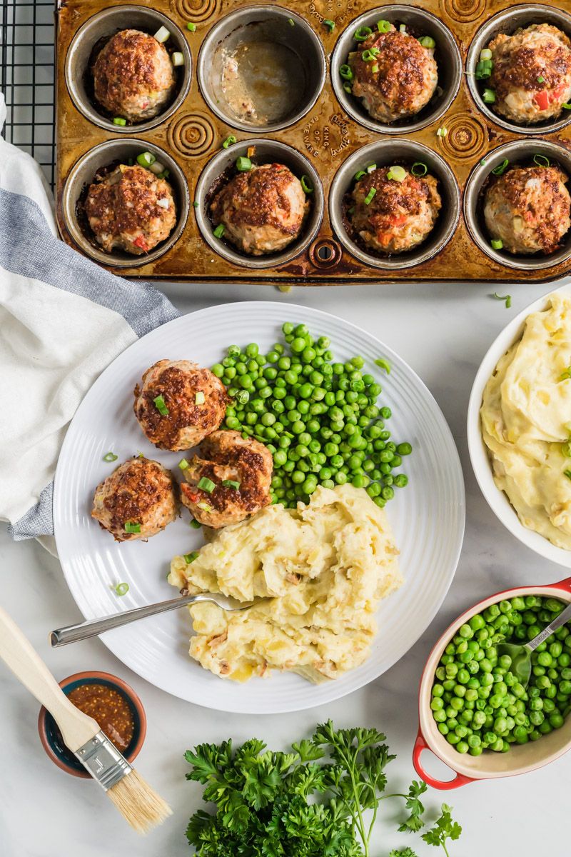 Turkey meatloaf muffins in a baking dish and served on a plate with mashed potatoes and peas.