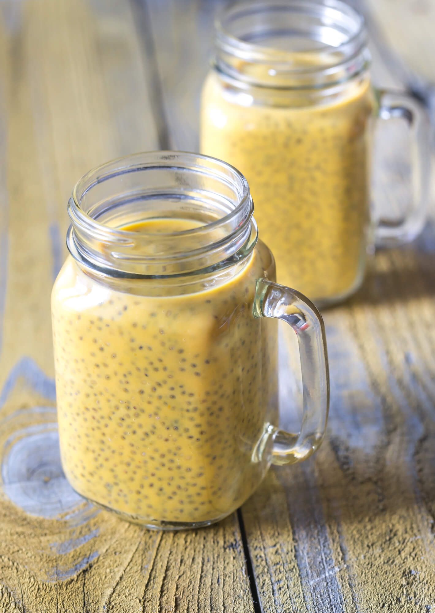 Two Pumpkin chia seed pudding in jars with a handle.