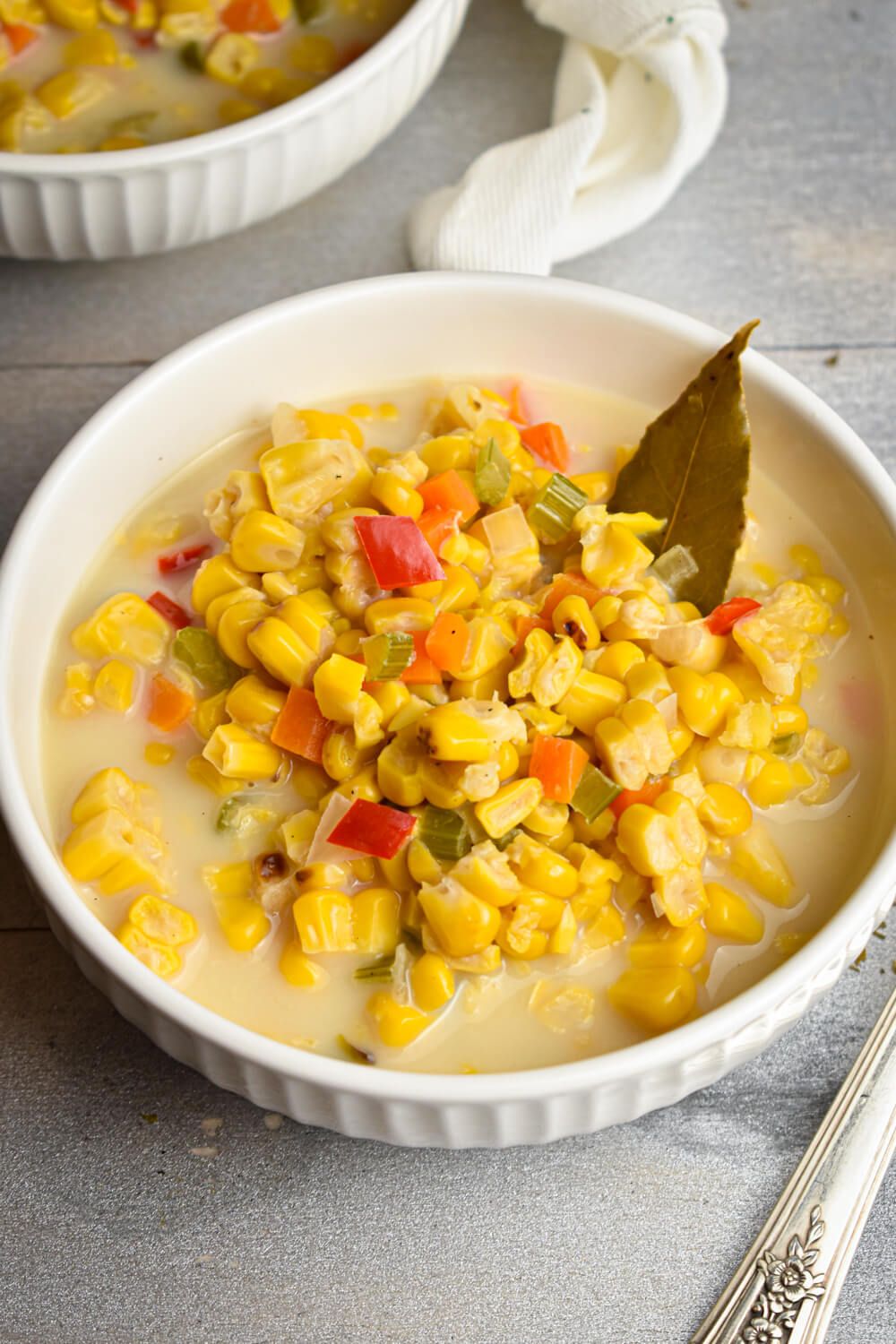Corn chowder with roasted corn, peppers, carrots, and celery in a creamy broth.