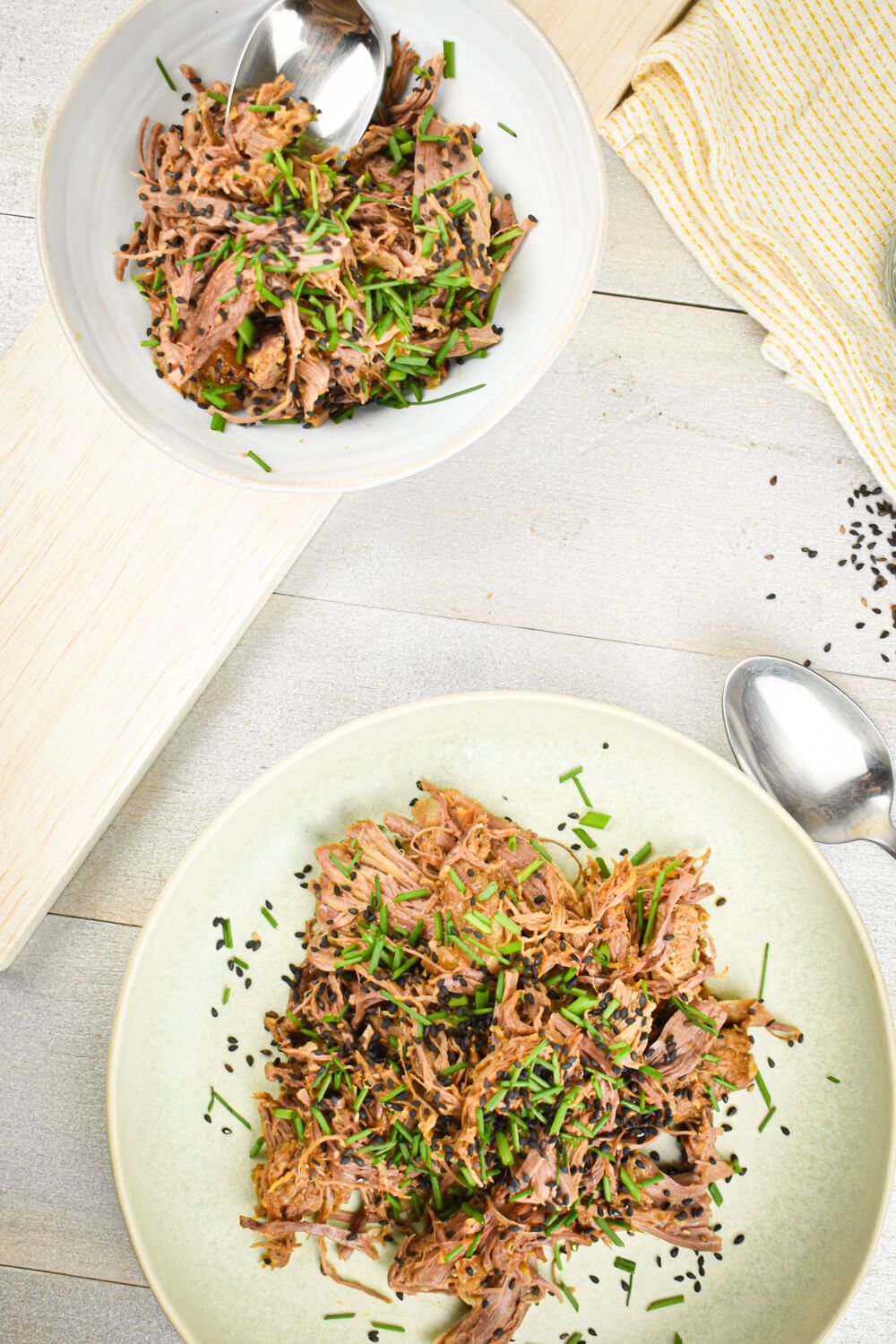 Sesame beef made in the slow cooker and shredded with green onions and sesame seeds.