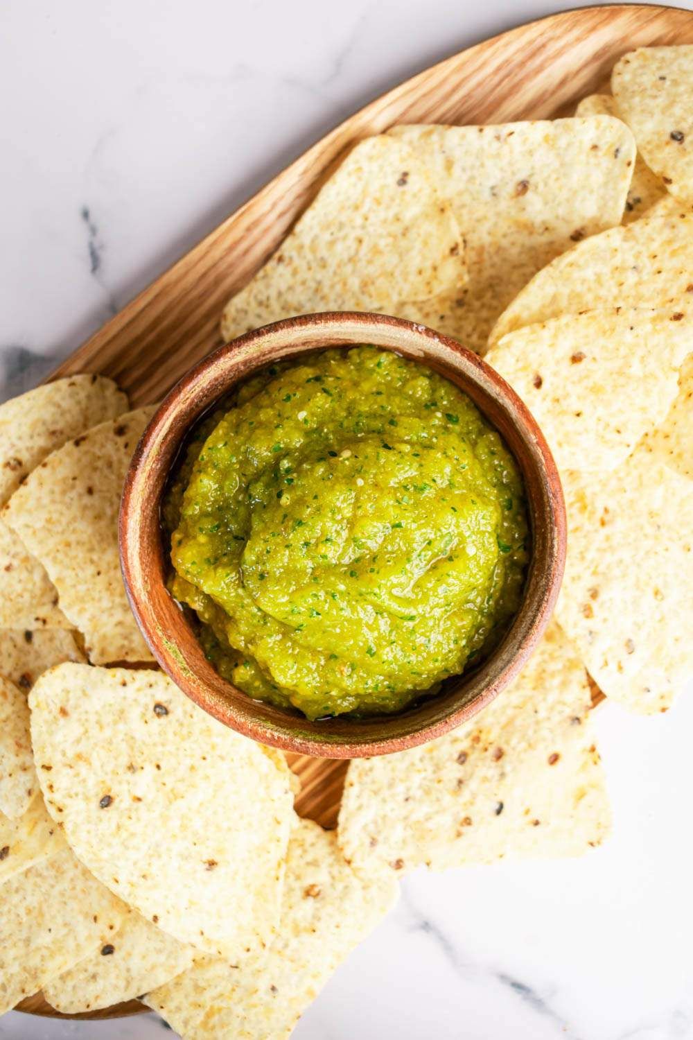 Tomatillo green salsa verde in a small bowl with tortilla chips.