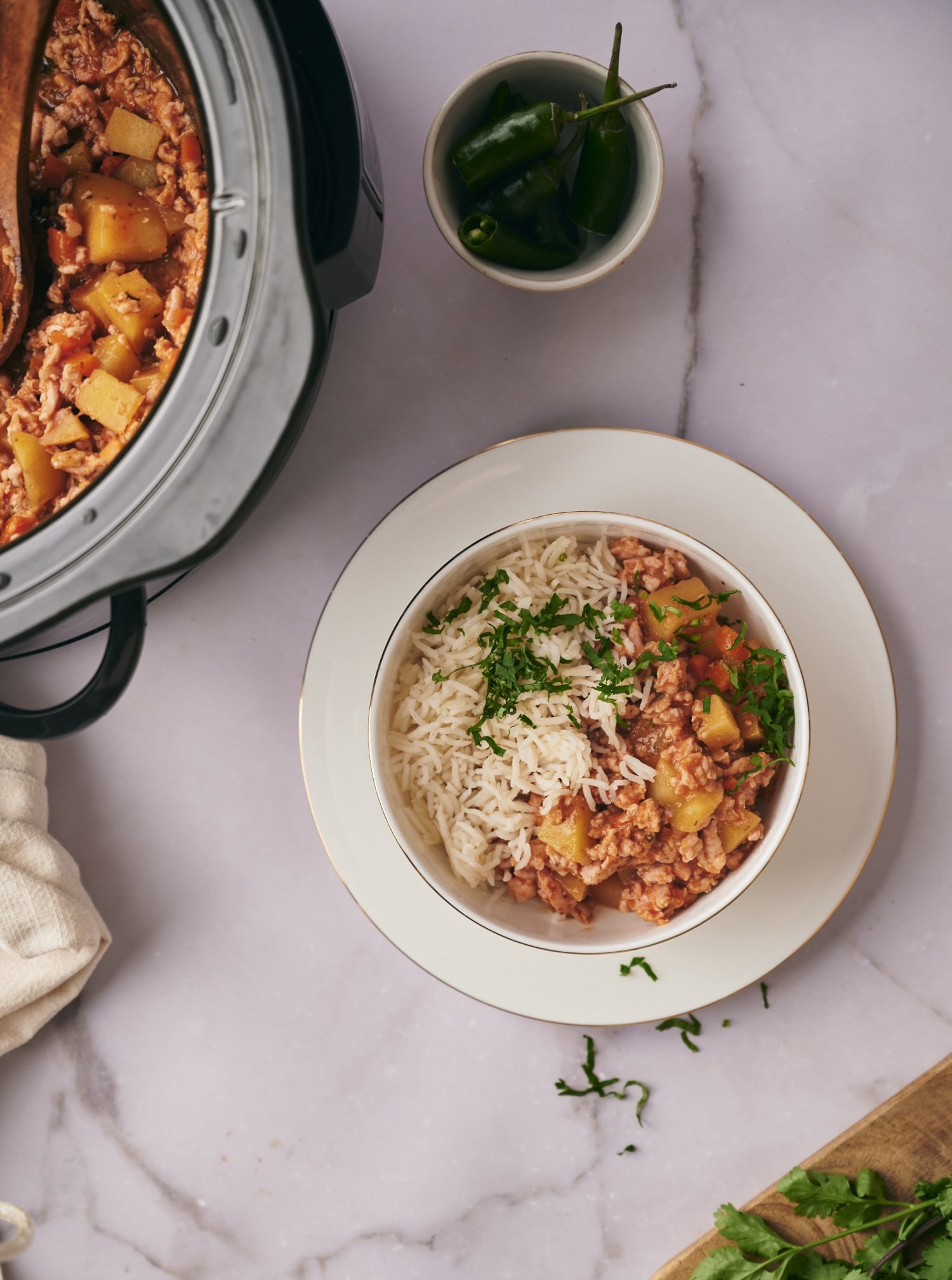 Picadillo that was cooked in the slow cooker and served in a bowl with white rice. 