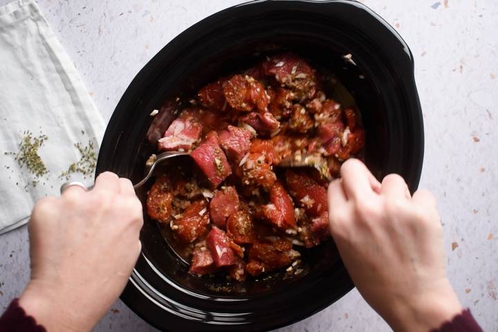 Lean beef in a slow cooker with tomatoes, beef broth, spices, and chipotle peppers.