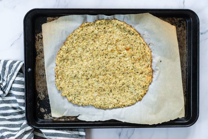 Cook cauliflower pizza crust on a baking sheet,