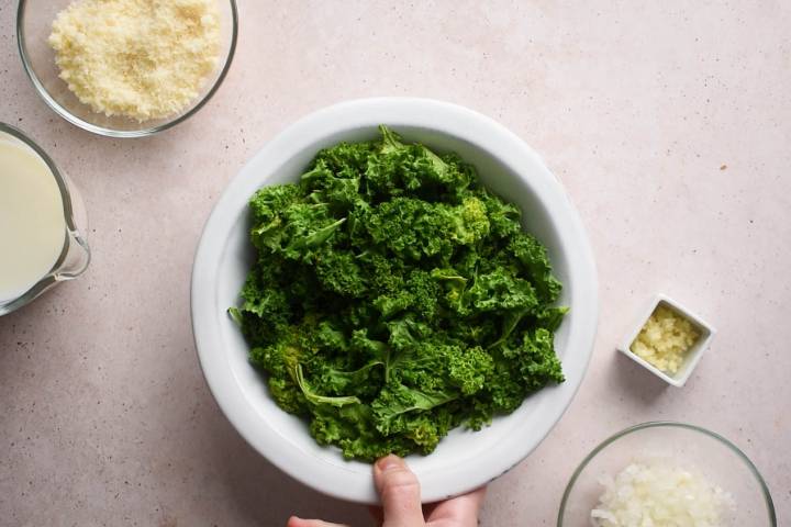 Cooked kale in a white bowl.