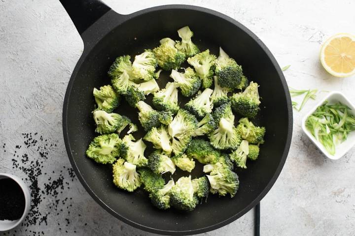 Broccoli cooking in a hot skillet.