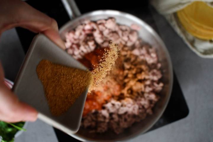 Lean ground turkey being cooked with salsa and taco seasoning.