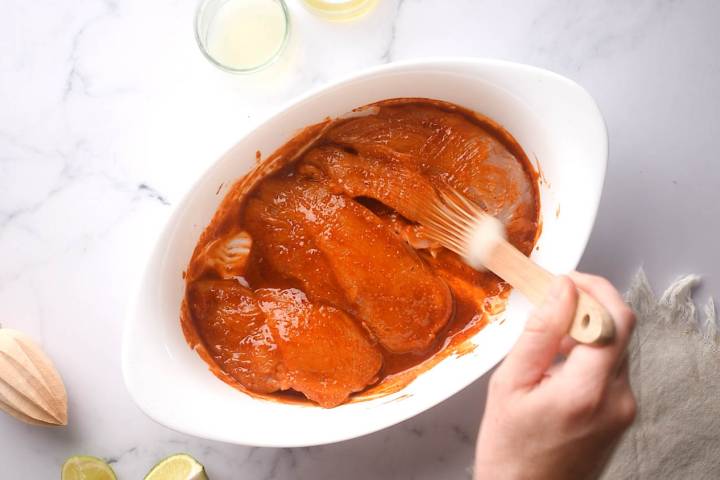 Chicken breast marinating in a paprika lime rub.