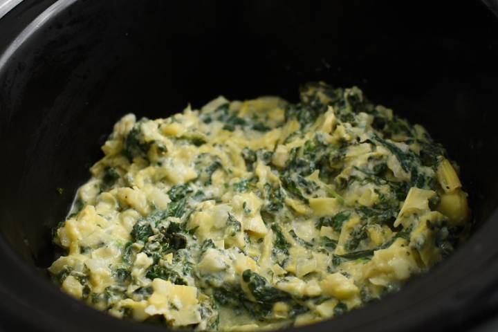 Slow cooker with spinach artichoke and kale dip.