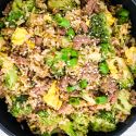 Beef and broccoli fried rice with eggs in a skillet.