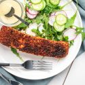 Blackened salmon with a homemade spice blend on a plate with salad.