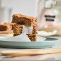 Peanut butter oatmeal bars cut into pieces and served in parchment paper.