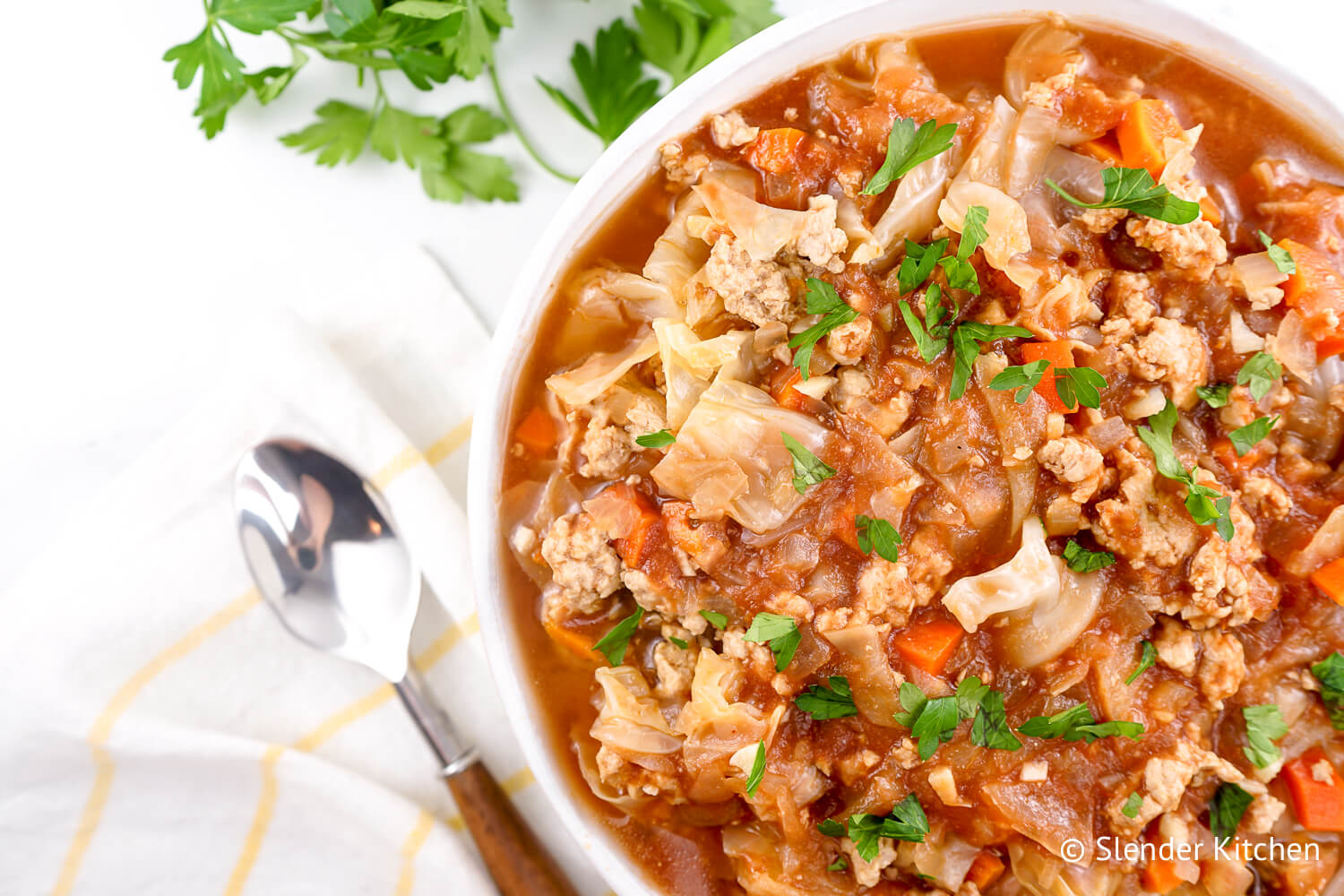 Zero point cabbage soup made with ground turkey, green cabbage, and tomatoes in a bowl with parlsey,