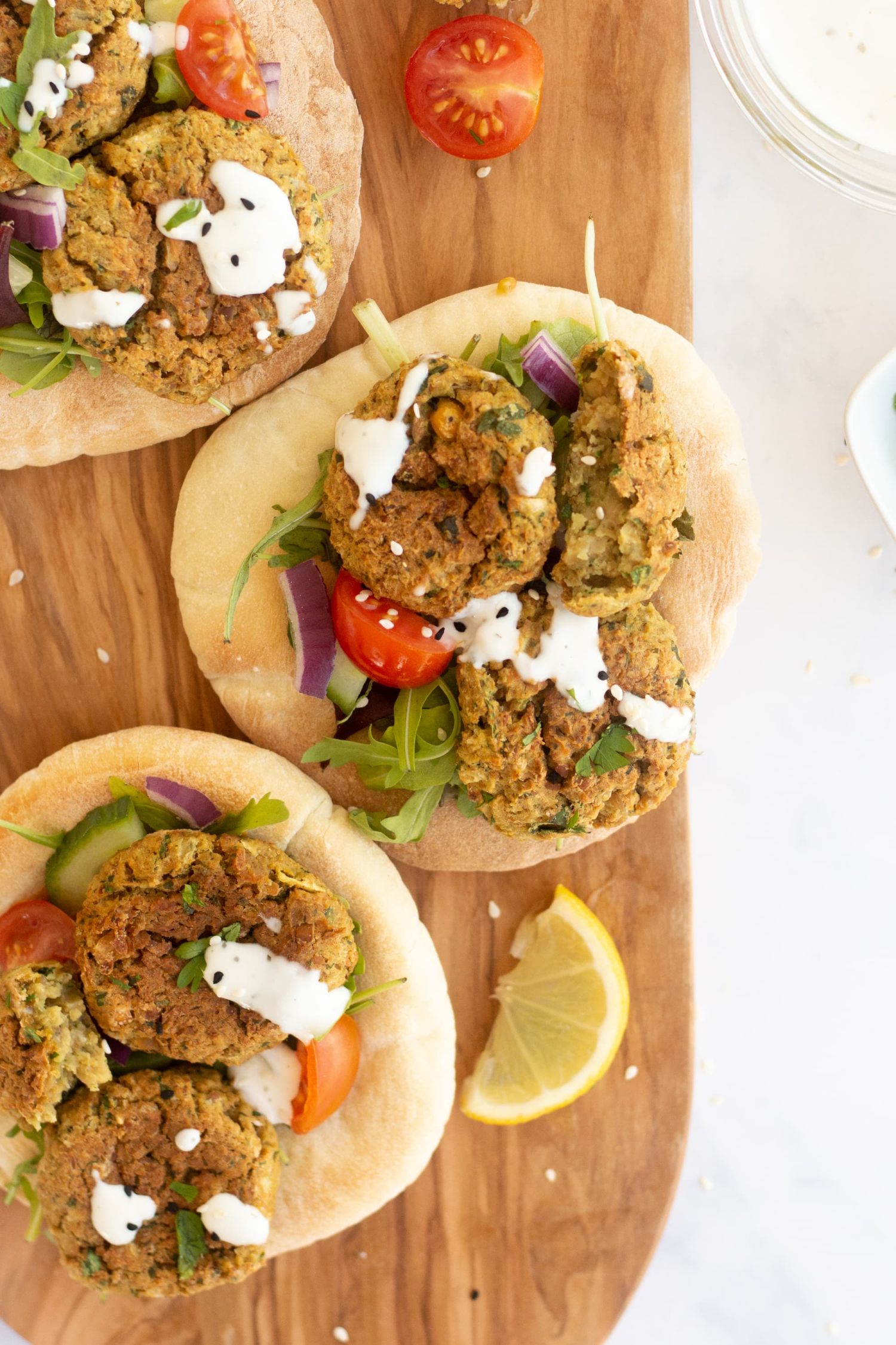 Crispy baked falafel served on pita bread with cucumber, tomato, lettuce, red onion, and tahini.