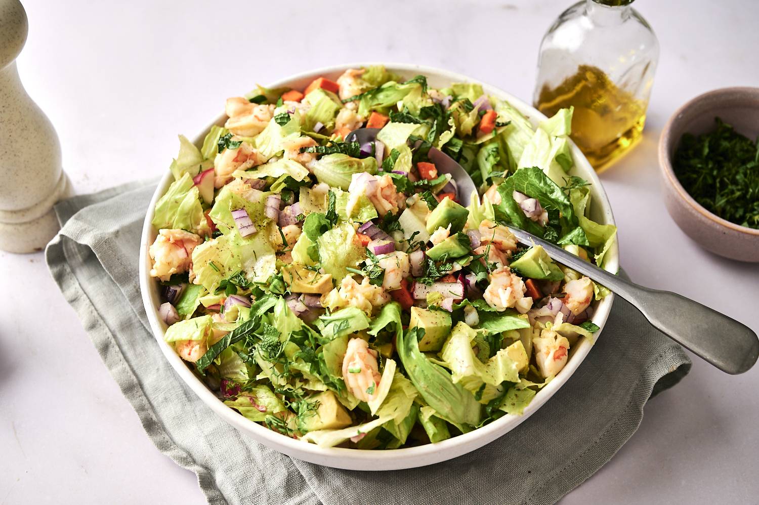 A close-up, eye-level shot of a bowl of chopped shrimp salad.