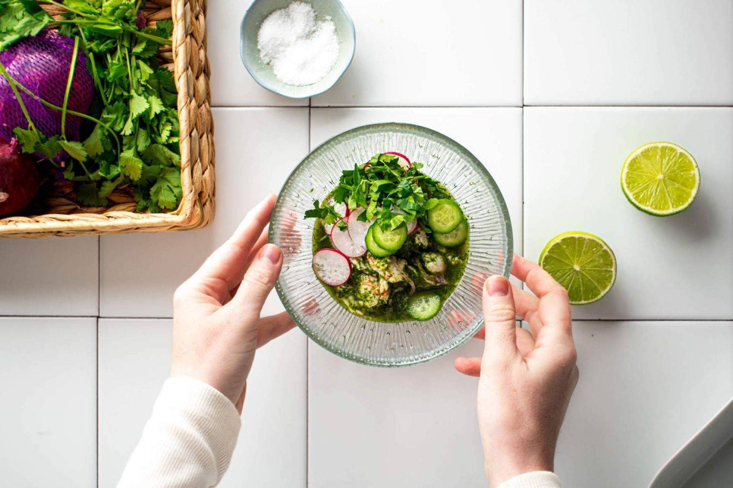 Mexican shrimp aguachile in a glass bow, with shrimp, lime juice, cilantro, and cucumbers.