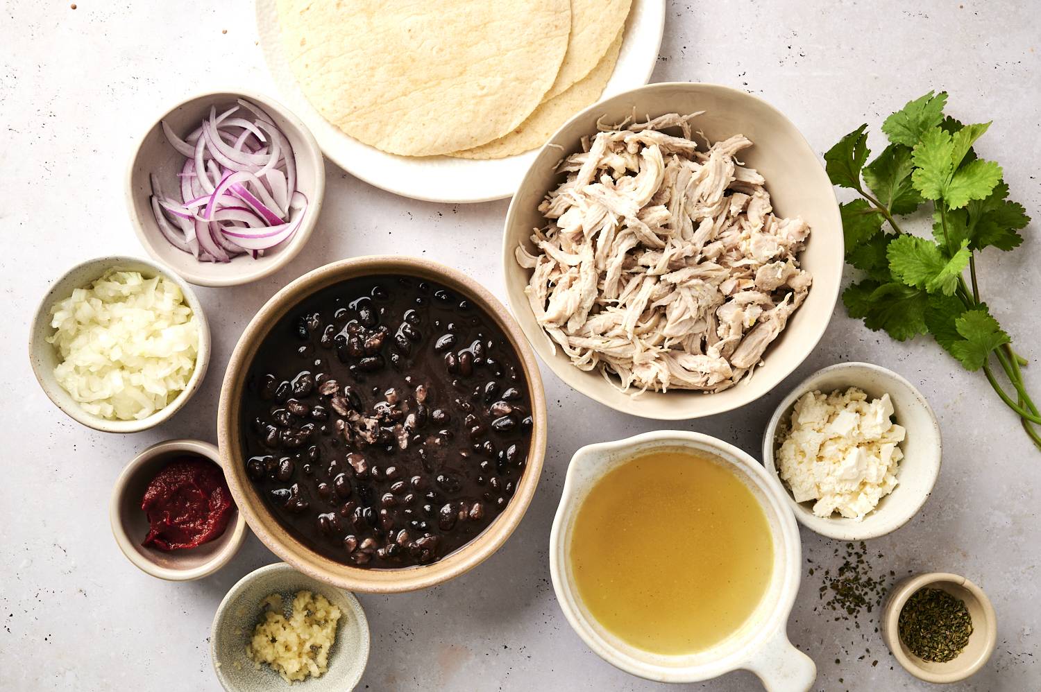 Ingredients needed to make Enfrijoladas on a counter.