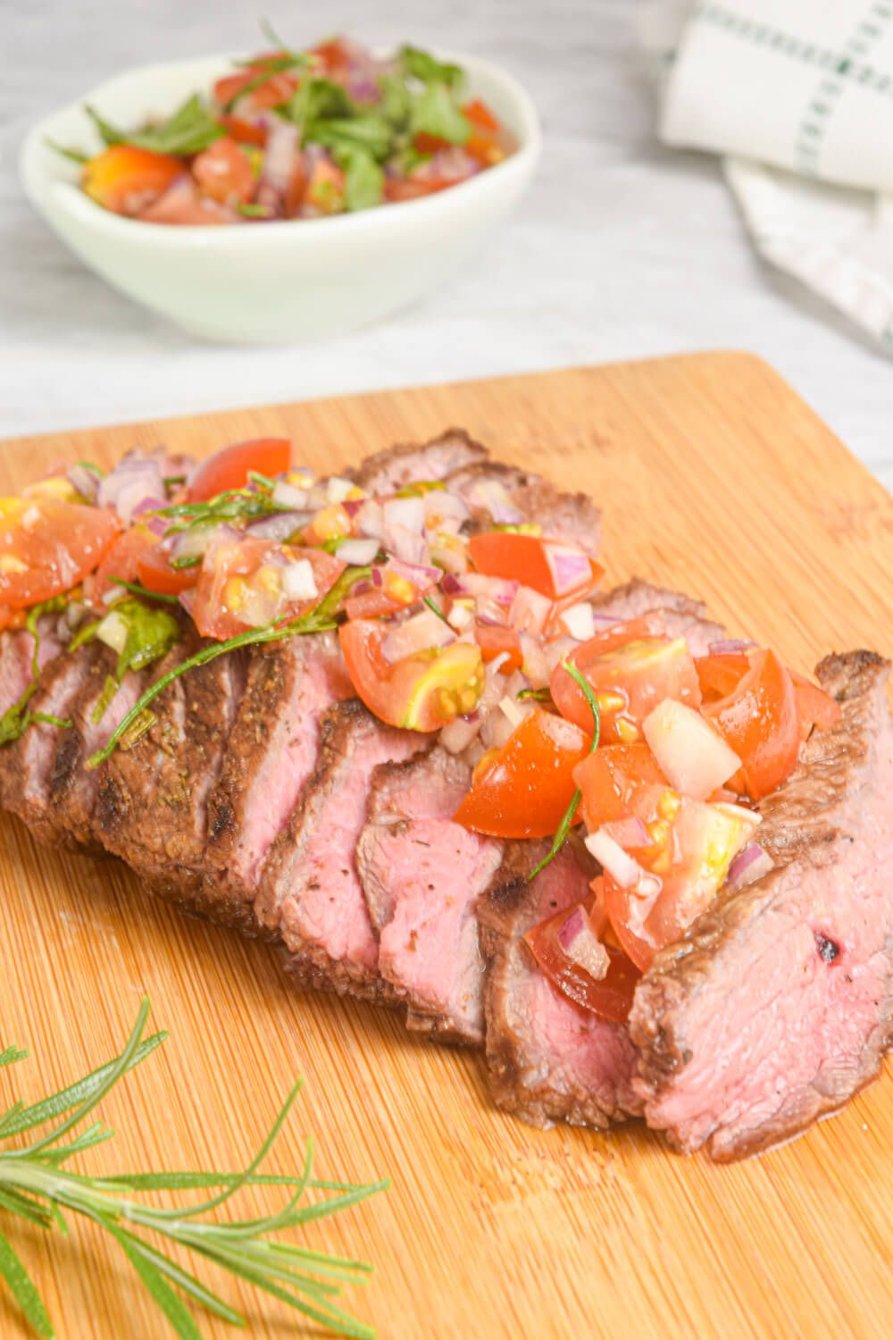 Marinated Spanish flank steak topped with tomatoes, basil, and red onions.