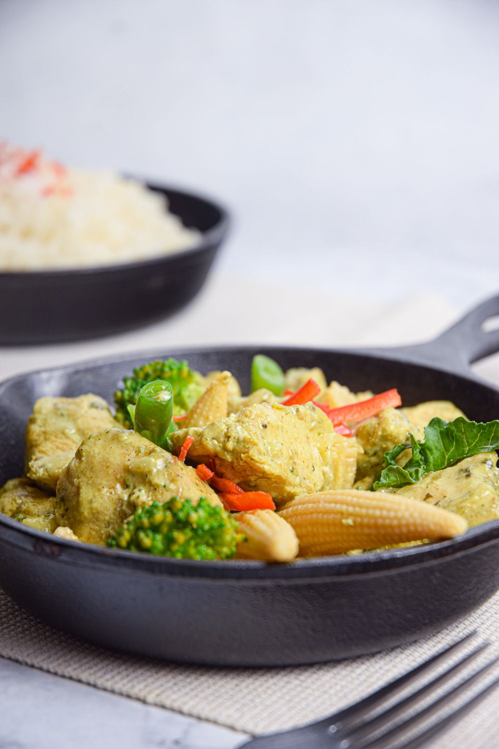 Crockpot Thai Green Curry Chicken and Vegetables in a small skillet with cilantro.