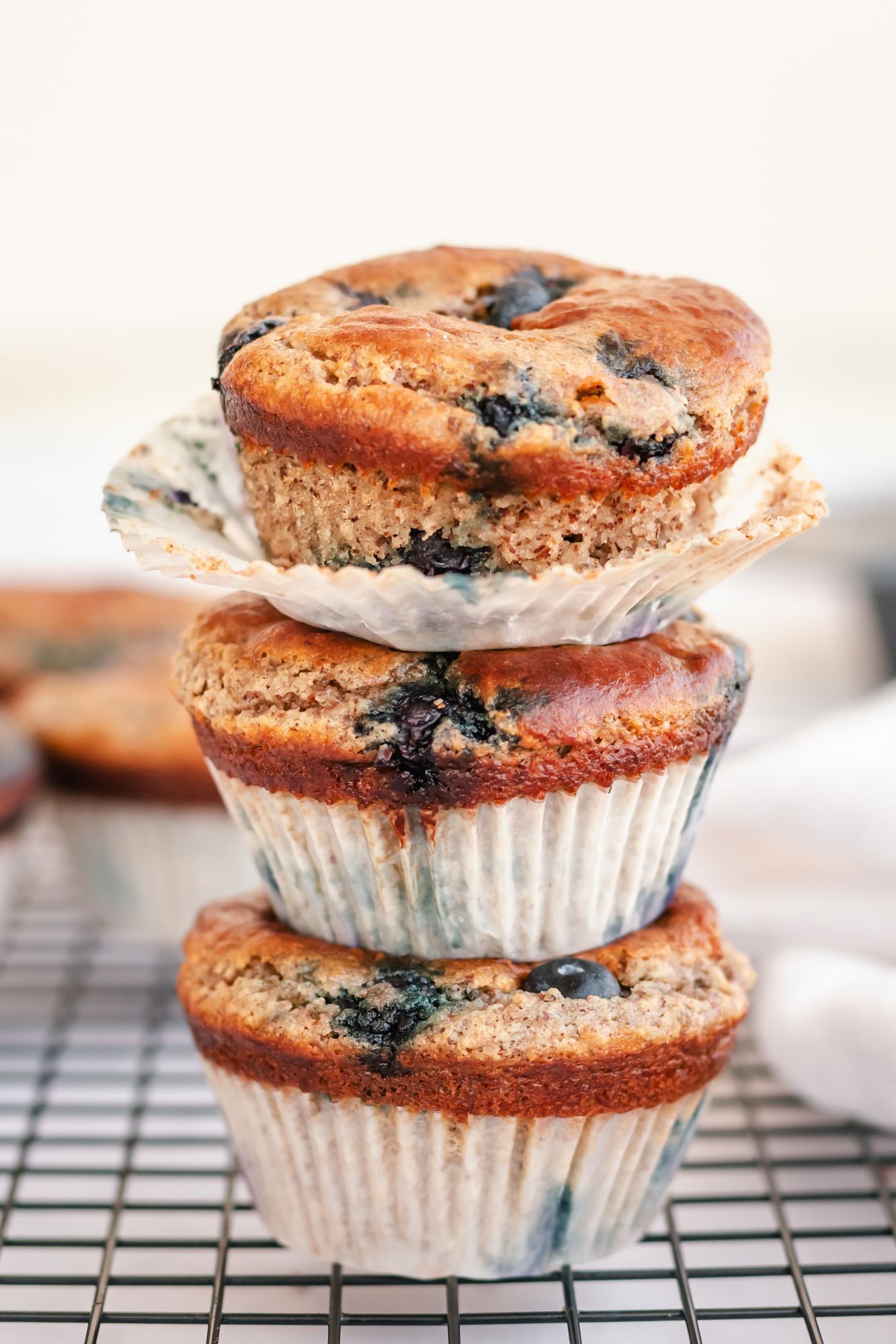 Low carb blueberry muffins with almond flour and walnuts stacked in a pile. 