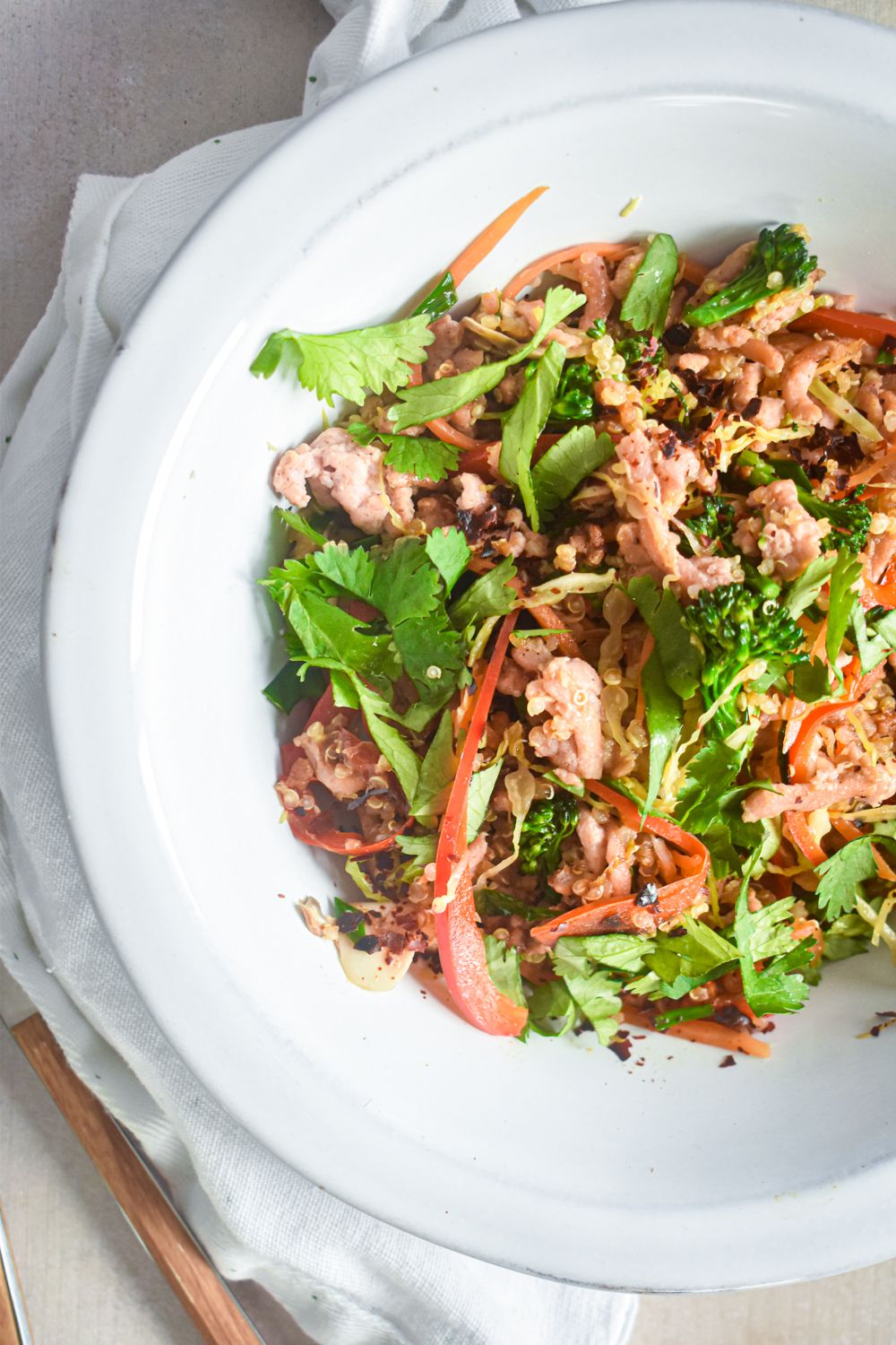 Stir fry with quinoa, ground turkey, and fresh vegetables cooked with stir fry sauce and served with fresh cilantro.