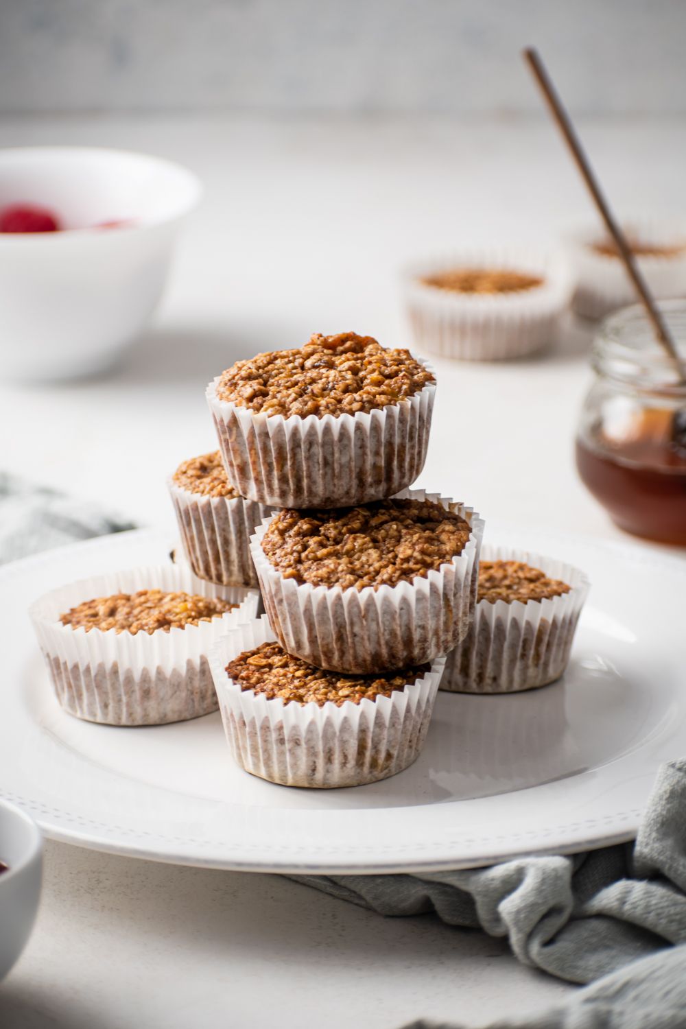 Oatmeal muffins made with rolled oats and bananas stacked on a plate. 