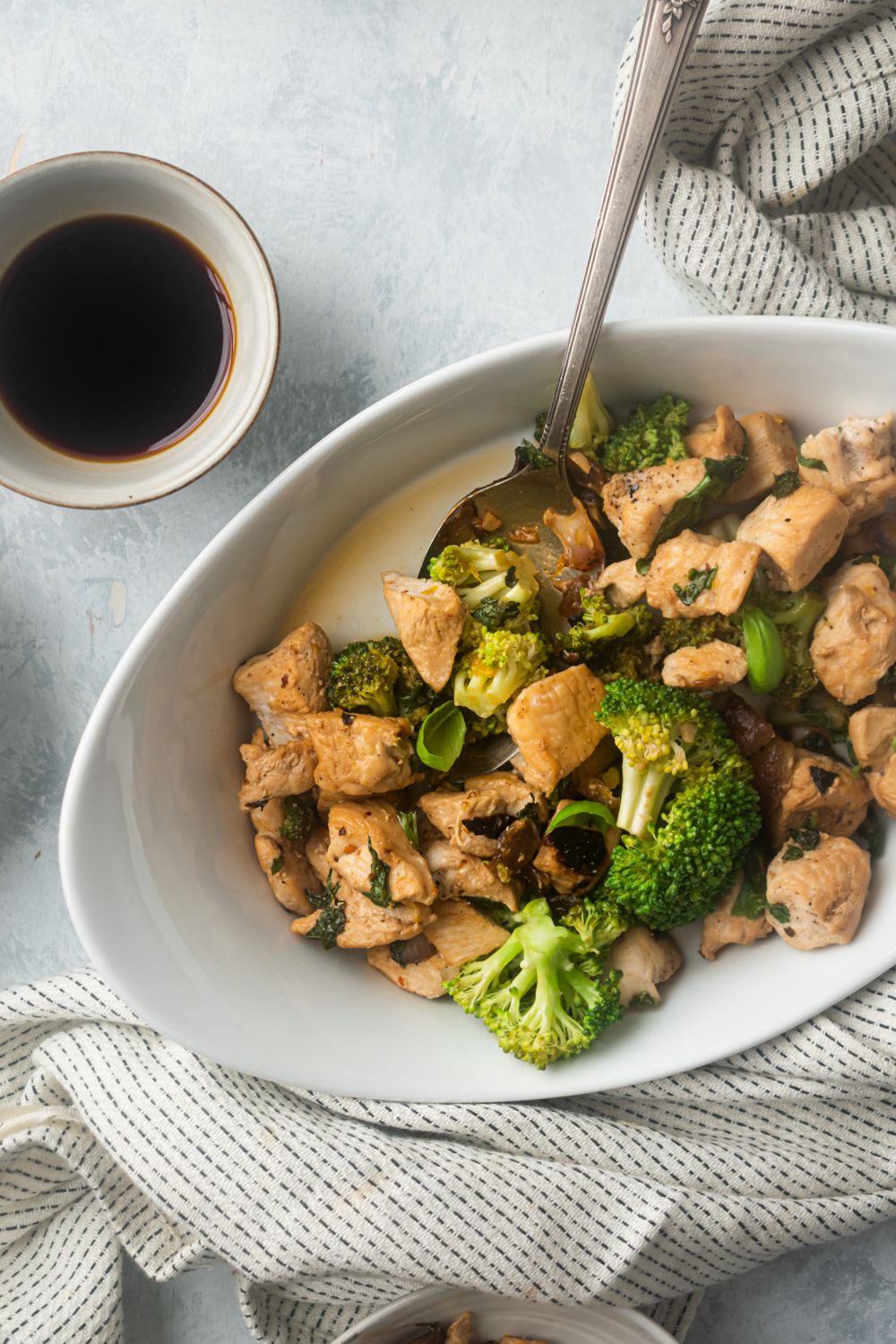 Basil chicken breast and basil stir fry with broccoli florets tossed in soy sauce and lemon juice.