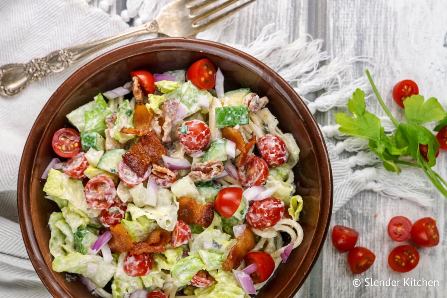Ranch BLT Pasta salad in a bowl with crispy bacon and vegetables in a bowl.