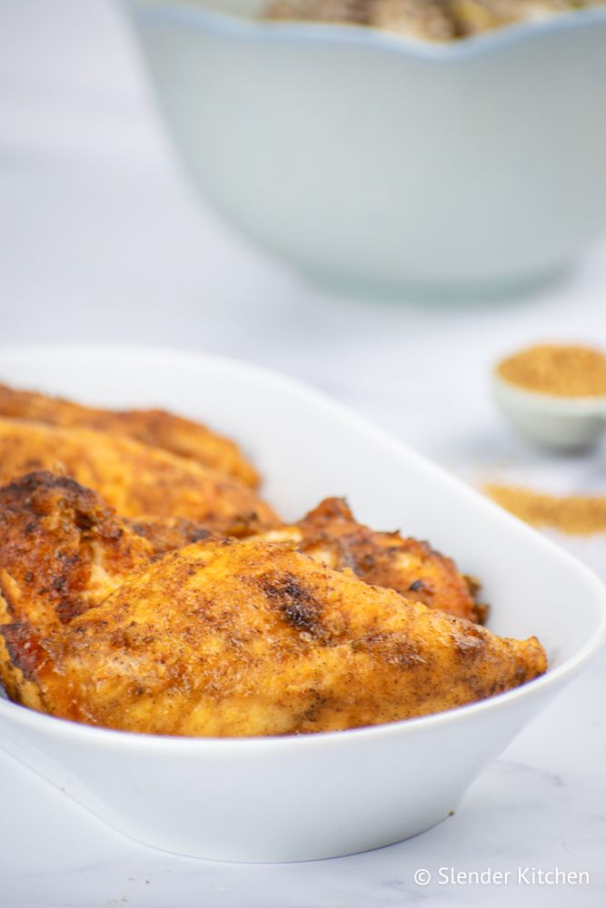 Skillet brown sugar chicken on a plate with a flour and paprika coating.