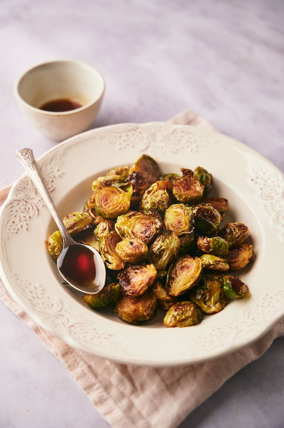 Balsamic caramelized brussels sprouts served in a bowl with glaze.