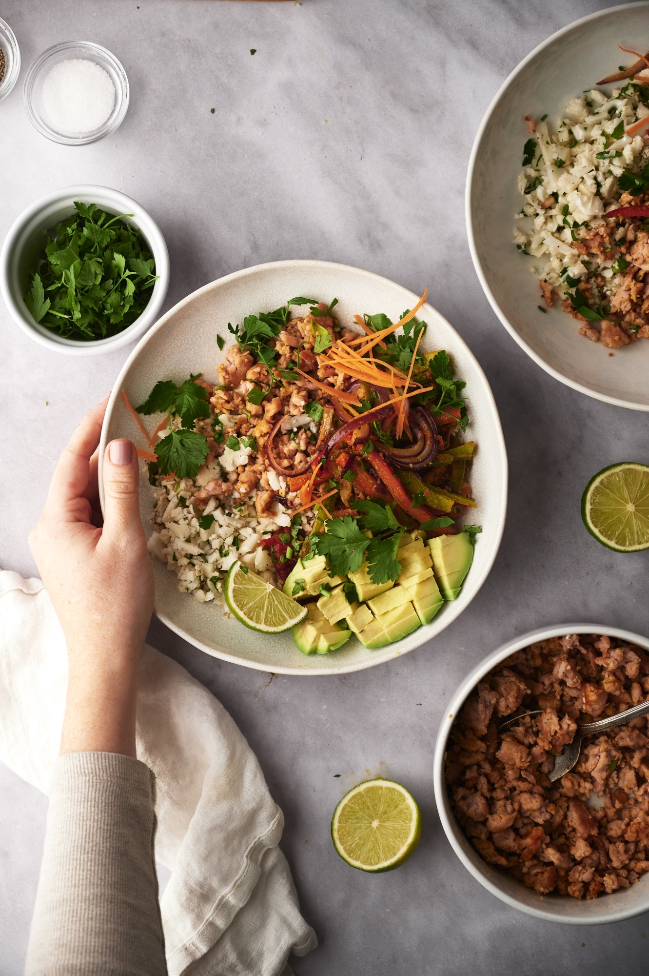 Cauliflower rice taco bowls with seasoned ground turkey, peppers, onions, avocado, and cauliflower rice.
