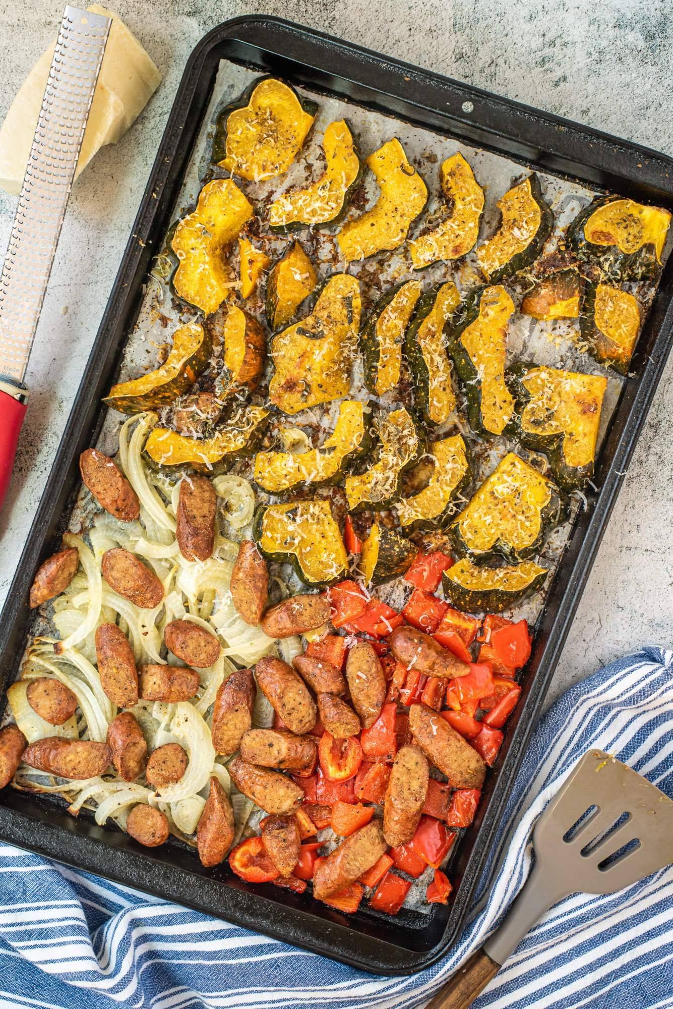Sheet pan chicken sausage with acorn squash, peppers, onions, and Parmesan cheese.
