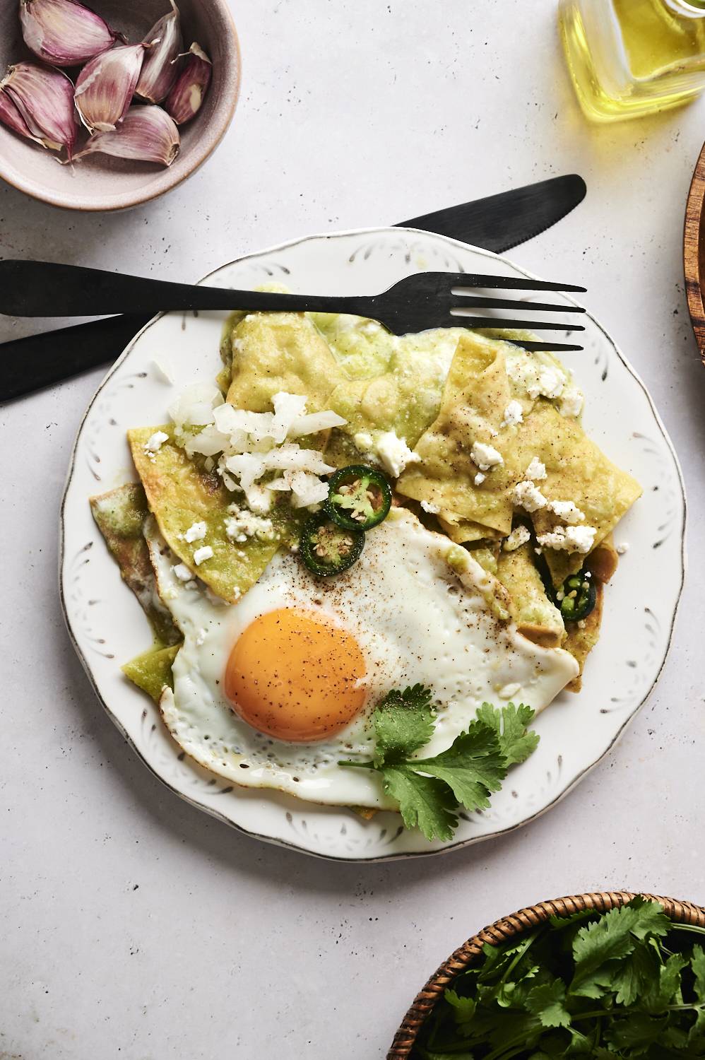 Chilaquiles verdes on a plate with a fried egg.