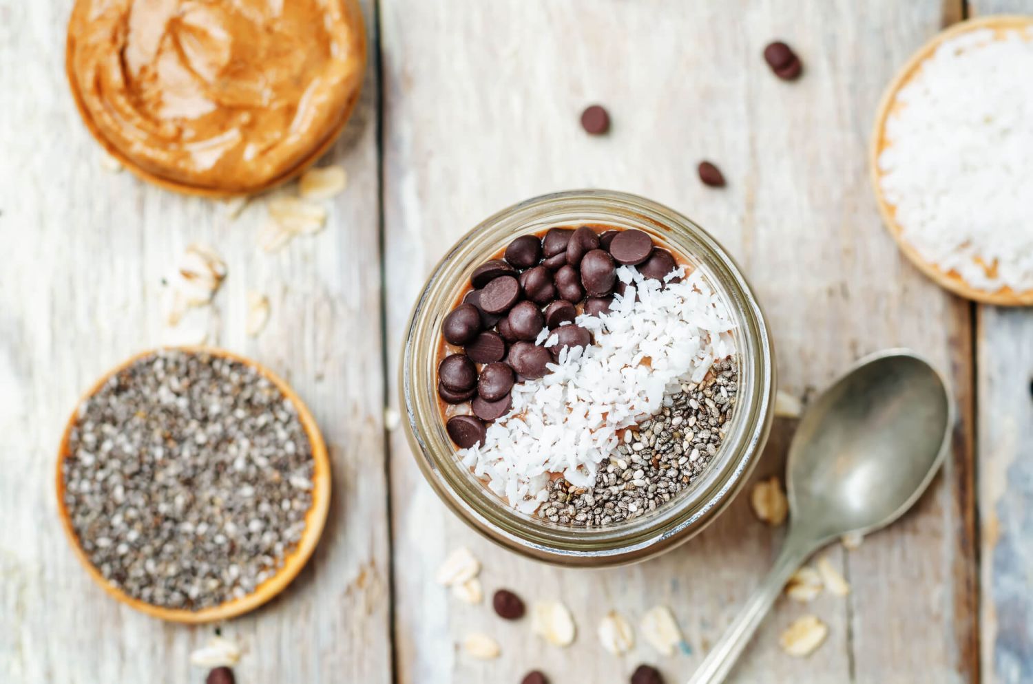 Chocolate Chia pudding in a jar with with coconut and chocolate chips.