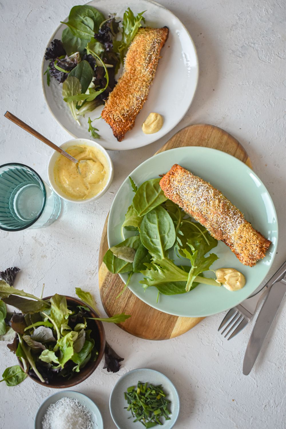 Salmon crusted with shredded coconut and cooked until crispy with greens on the side.
