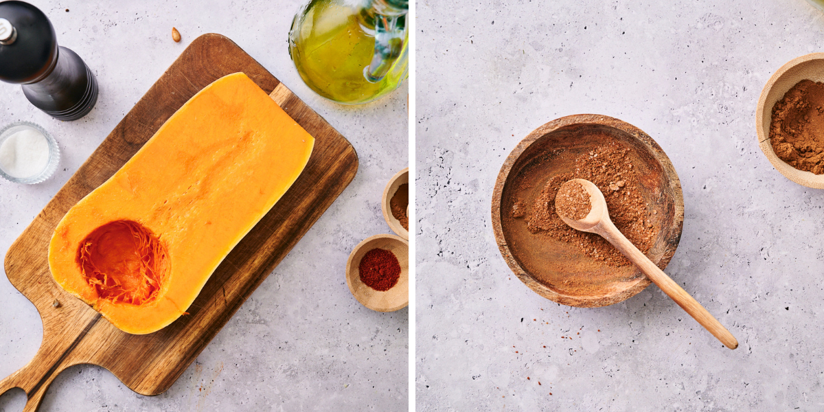 A halved butternut squash on a cutting board, surrounded by spices and olive oil, alongside a bowl of mixed spices and a wooden spoon.