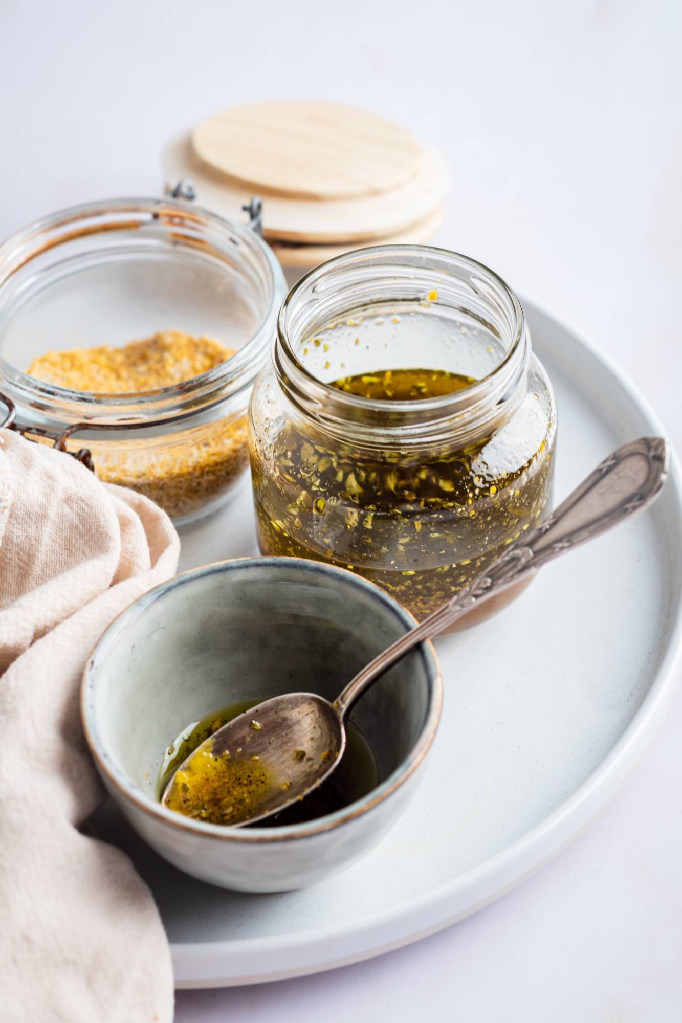 Lemon pepper marinade in a glass jar with lemon pepper seasoning on the side.