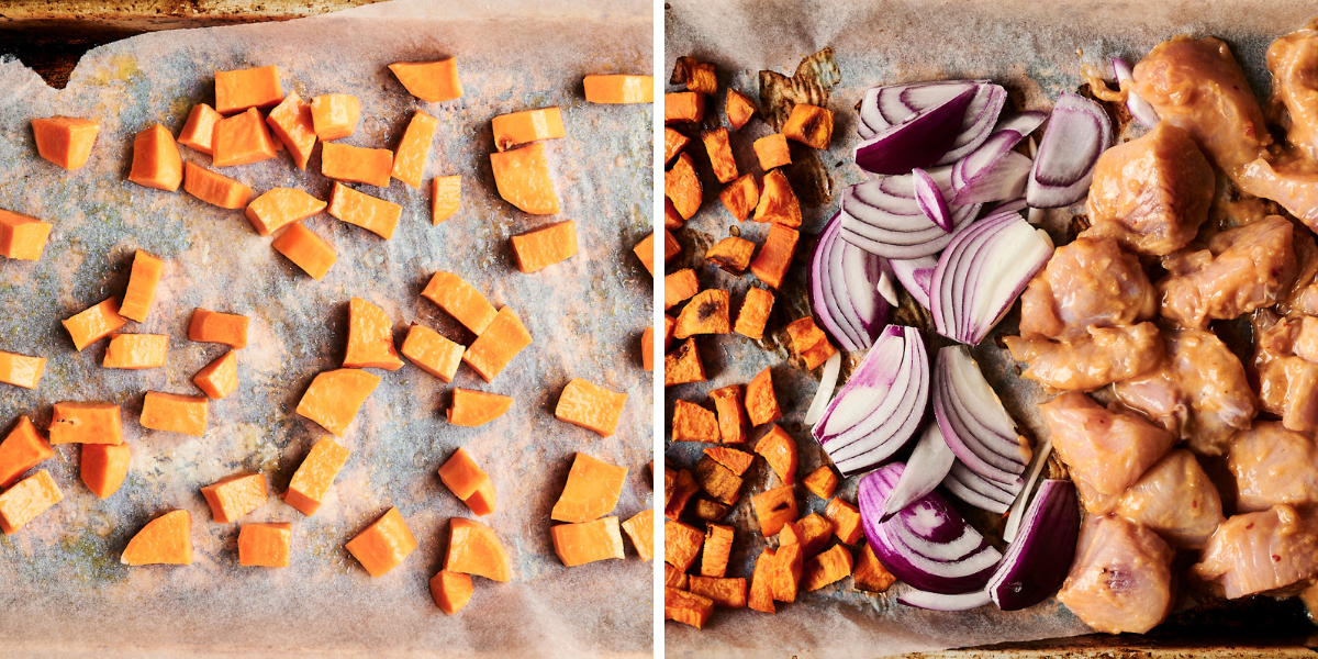 A baking sheet lined with parchment holds diced sweet potatoes, red onions, and marinated chicken pieces, ready for roasting.