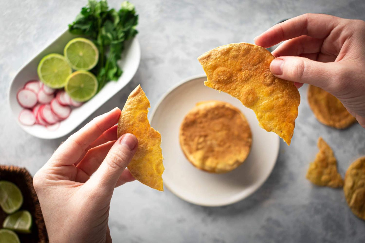Crispy baked tostadas made with corn tortillas cooked until crisp and being broken between two hands,